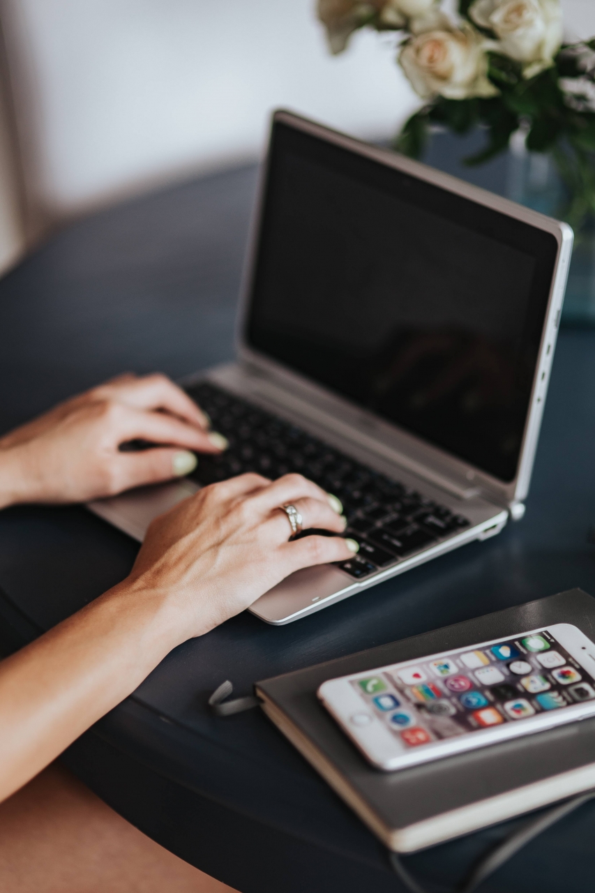 Person reviewing mobile app security on a laptop