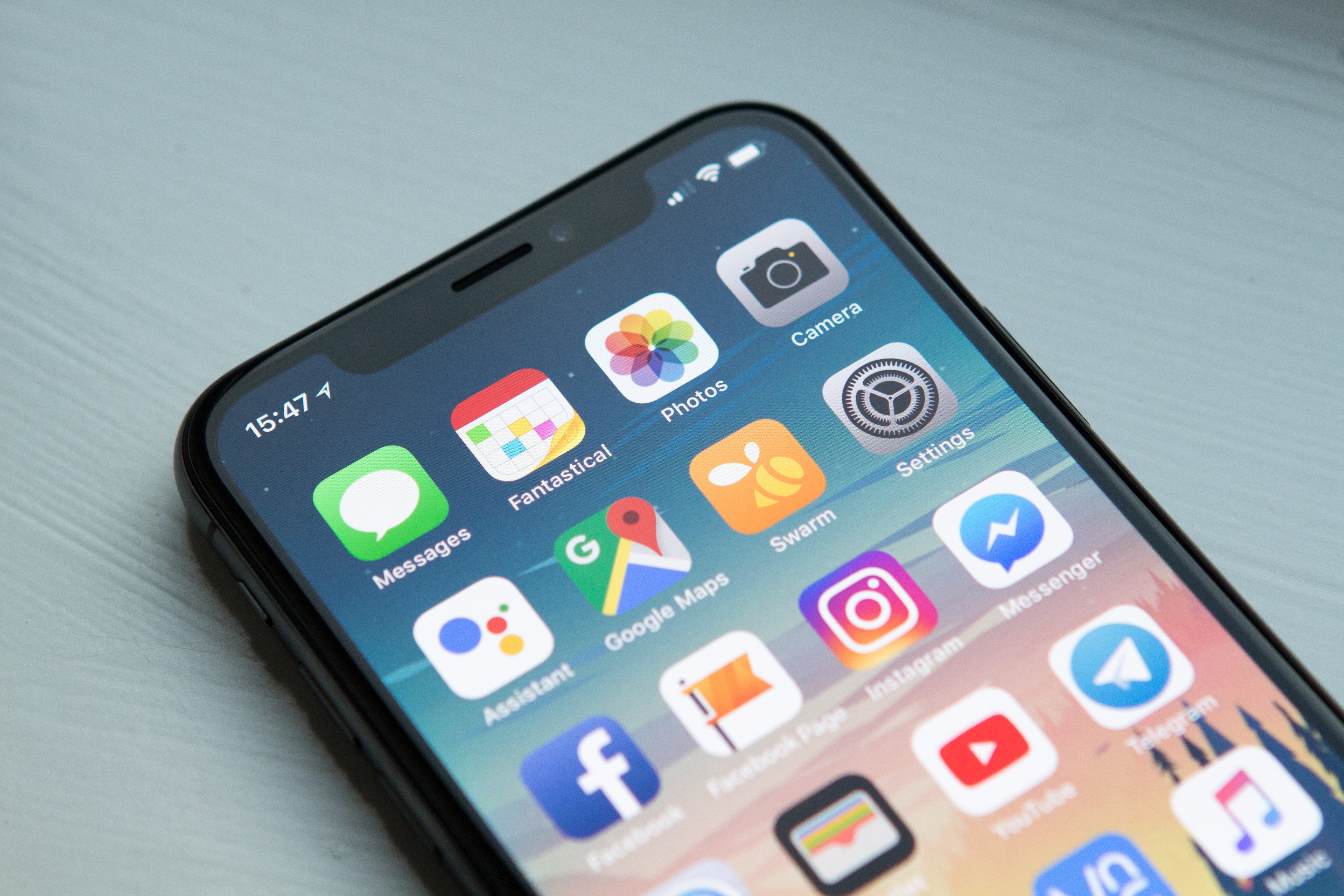 iPhone X with apps on the main screen