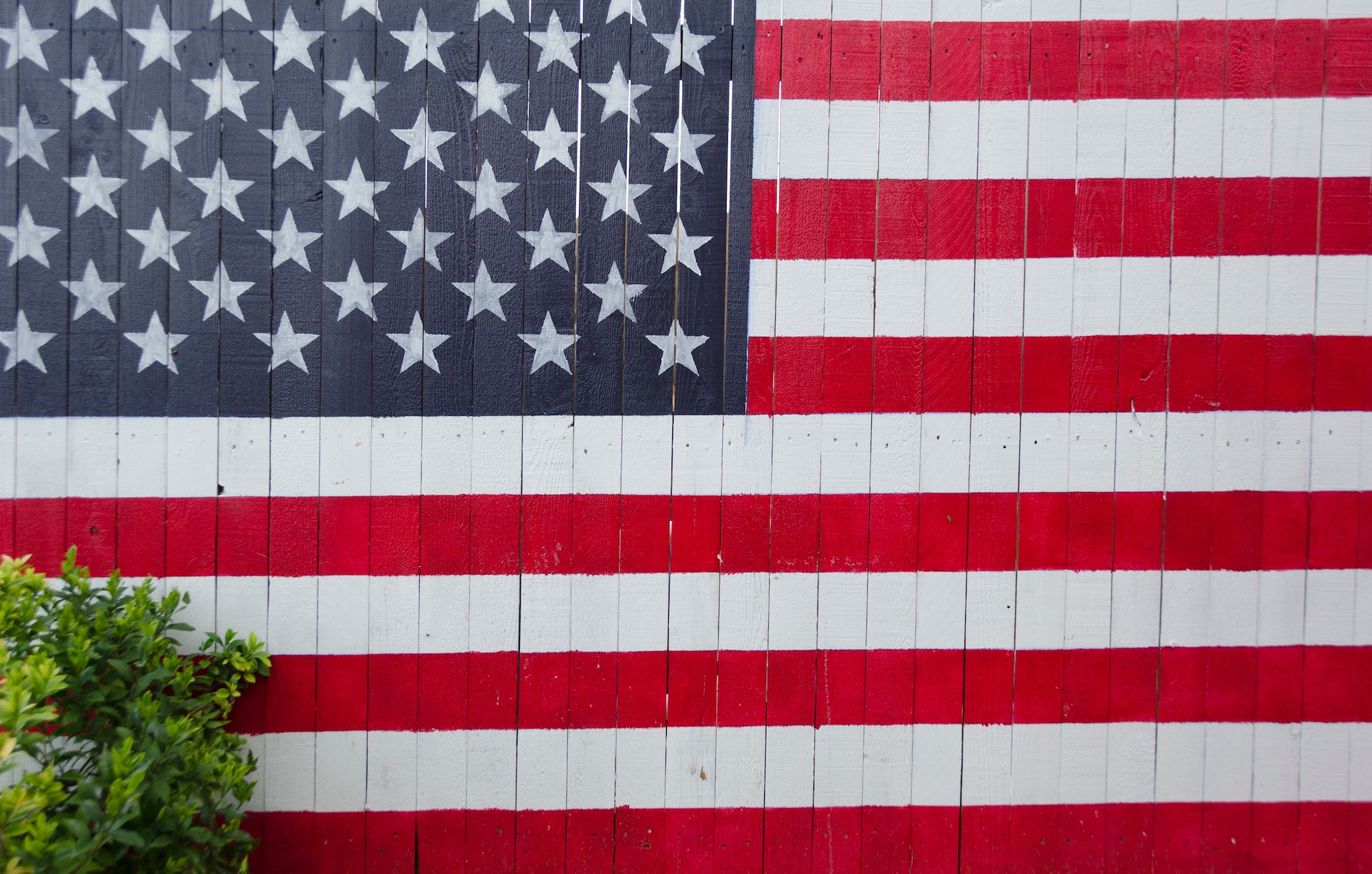 american flag painted on an old fence