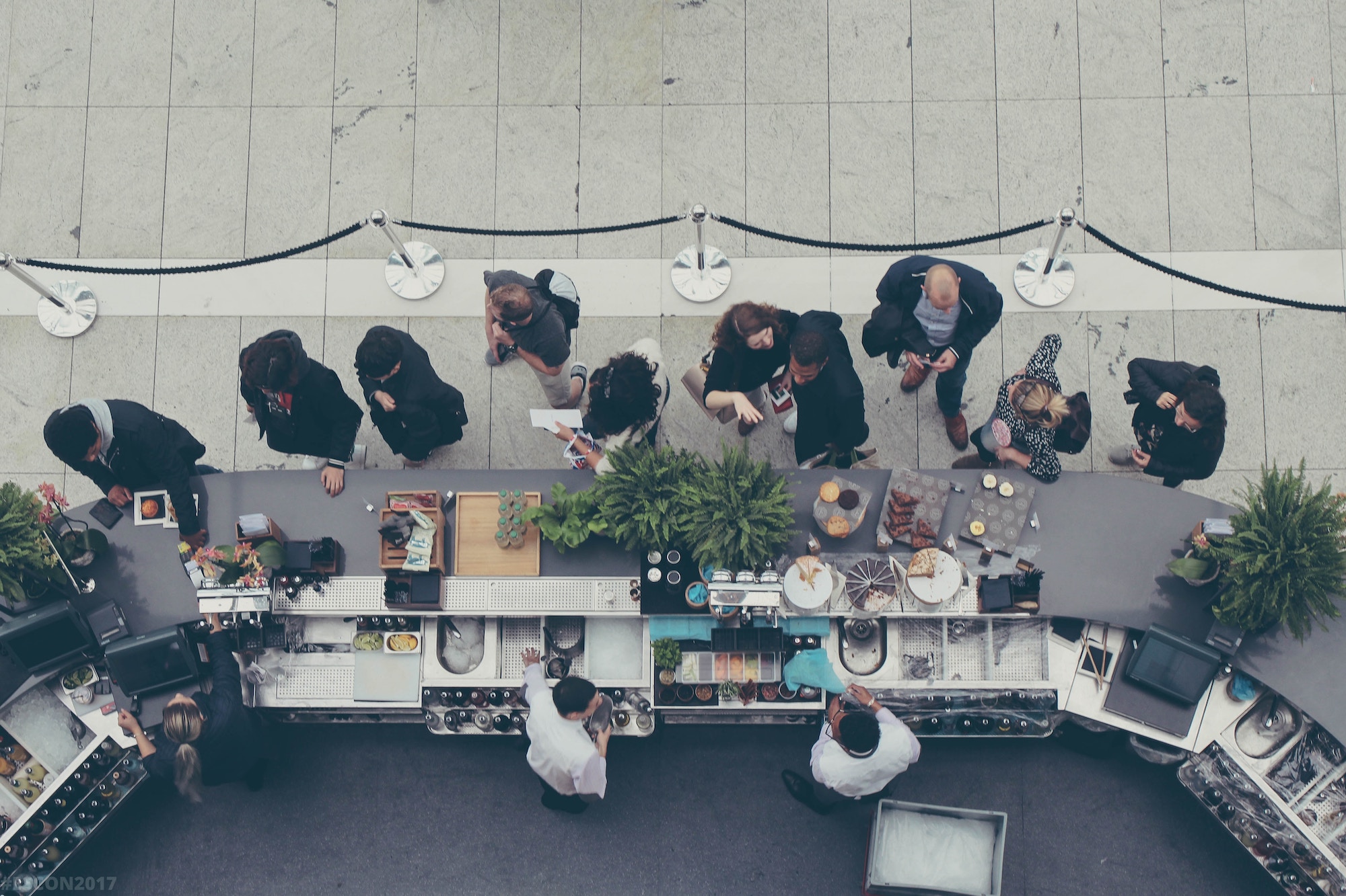 customers waiting in line at a food stand